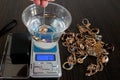 pawnshop worker determines the ring of gold jewelry using the Hydrostatic weighing method by Archimedes\' law