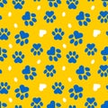 Paws of a cat, dog, puppy. Seamless cute pattern of animal footprints for textile. Blue and yellow colors.