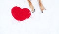 Valentines Day card with dog on white background. Paws of German Shepherd of red color on snow with large soft toy red heart Royalty Free Stock Photo