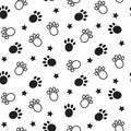 Paws seamless vector pattern. Animal tracks black and white background. Royalty Free Stock Photo