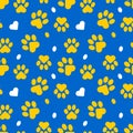 Paws of a cat, dog, puppy. Seamless cute pattern of animal footprints for textile. Blue and yellow colors.