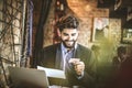 Pay bills online is great. Young business man at coffee break. Royalty Free Stock Photo