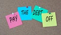 PAY THE DEBT OFF - words on colorful pieces of paper attached to the note board Royalty Free Stock Photo