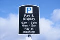 Pay and display payment coins at machine sign in sky Royalty Free Stock Photo