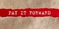 PAY IT FORWAR appearing behind on torn paper Royalty Free Stock Photo