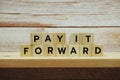 Pay It Forward alphabet letter on shelves wooden background Royalty Free Stock Photo