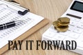 PAY IT FORWARD text with chart and calculator and coins , business concept Royalty Free Stock Photo