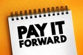 PAY IT FORWARD text on notepad, concept background Royalty Free Stock Photo