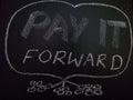 pay it forward word displayed on chalkboard concept Royalty Free Stock Photo