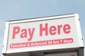 pay here patrolled and enforced 24 hours 7 days rectangle sign above pay meter. Ph Royalty Free Stock Photo