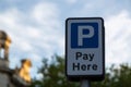 a pay here sign in a car park Royalty Free Stock Photo