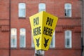 a pay here sign on top of a pay and display ticket car park machine Royalty Free Stock Photo