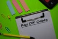 Pay Off Debts write on a paperwork isolated on Office Desk Royalty Free Stock Photo