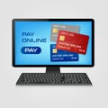 Pay online and online shopping concept - computer with credit cards on screen