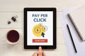 Pay Per Click concept on tablet screen with office objects Royalty Free Stock Photo