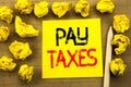 Pay Taxes. Business concept for Taxation Overtax Return written on sticky note paper on the vintage background. Folded yellow pape