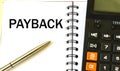 PAYBACK word in a notebook against the background of calculitar