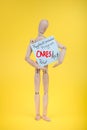 Paycheck program CARES Act government relief sign held by wooden figure on yellow background