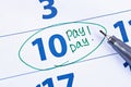 Payday concept. Business, finance, savings money. Calendar with marker circle in word payday Royalty Free Stock Photo