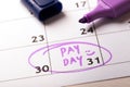 Payday concept calendar with marker and circled day of salary Royalty Free Stock Photo