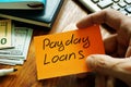 Payday loans written on a piece of paper Royalty Free Stock Photo