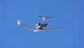 Executive Jetliner Aerodynamic Elegance in Sunlit Blue Sky in Slow Motion