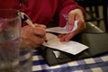 Hands Calculating Tip on Restaurant Receipt Royalty Free Stock Photo