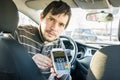 Paying for transportation. Taxi driver is offering payment terminal to customer Royalty Free Stock Photo