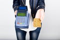 Payment card in a bank terminal. The concept of of electronic payment. Closeup of a woman hand holding credit card over Royalty Free Stock Photo