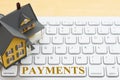 Payment message with a model house on gray keyboard