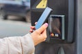 Payment for parking using contactless NFC technology supported Visa and Mastercard. Closeup womans hand using a Royalty Free Stock Photo