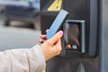 Payment for parking using contactless NFC technology supported Visa and Mastercard. Closeup womans hand using a