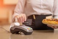 Payment for seris to a pizza serving restaurant, the waiter waits and accepts payment for pizza Royalty Free Stock Photo