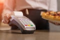 Payment for seris to a pizza serving restaurant, the waiter waits and accepts payment for pizza Royalty Free Stock Photo