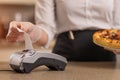 Payment for seris to a pizza serving restaurant, the waiter waits and accepts payment for pizza Royalty Free Stock Photo