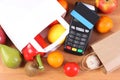 Payment terminal, contactless credit card and paper shopping bag Royalty Free Stock Photo