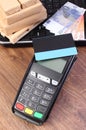 Payment terminal with credit card, currencies euro, laptop and wrapped boxes on pallet Royalty Free Stock Photo