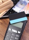 Payment terminal with credit card, currencies euro, laptop and wrapped boxes on wooden pallet Royalty Free Stock Photo