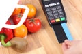 Payment terminal with credit card, fruits and vegetables, cashless paying for shopping Royalty Free Stock Photo