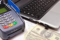 Payment terminal with credit card, money, laptop and financial calculations Royalty Free Stock Photo