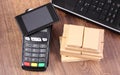 Payment terminal with smartphone with NFC technology, laptop and boxes on pallet, cashless paying for shipping and products Royalty Free Stock Photo