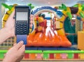 Payment for visiting a children`s entertainment center. Modern payment blue terminal