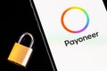 Payoneer logo mobile app on screen smartphone iPhone with lock closeup