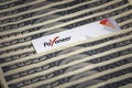 Payoneer prepaid plastic debit card on hundred dollar bills