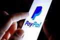 Paypal app icon on the smartphone screen and finger launching it Royalty Free Stock Photo