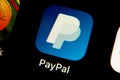 PayPal app logo on iPhone screen. Cellphone with an icon of a biggest online payment company on a market.