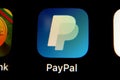 PayPal app logo on iPhone screen. Cellphone with an icon of a biggest online payment company on a market. Royalty Free Stock Photo