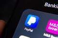 PayPal app seen on the edge of smartphone screen in a group with other banking apps as M