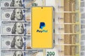 Paypal application on smartphone on dollars and euros bills Royalty Free Stock Photo