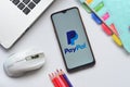 paypal apps on smartphone with laptop and book Royalty Free Stock Photo